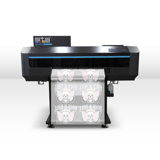 An STS XPD924 machine shown from the side, printing a roll of white material with repeated pink and gray butterfly graphics and the words 'ROCK N'ROLL'.